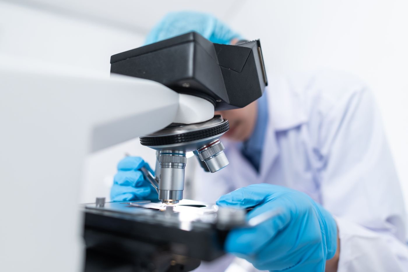 Scientist examining a sample under a microscope in a laboratory